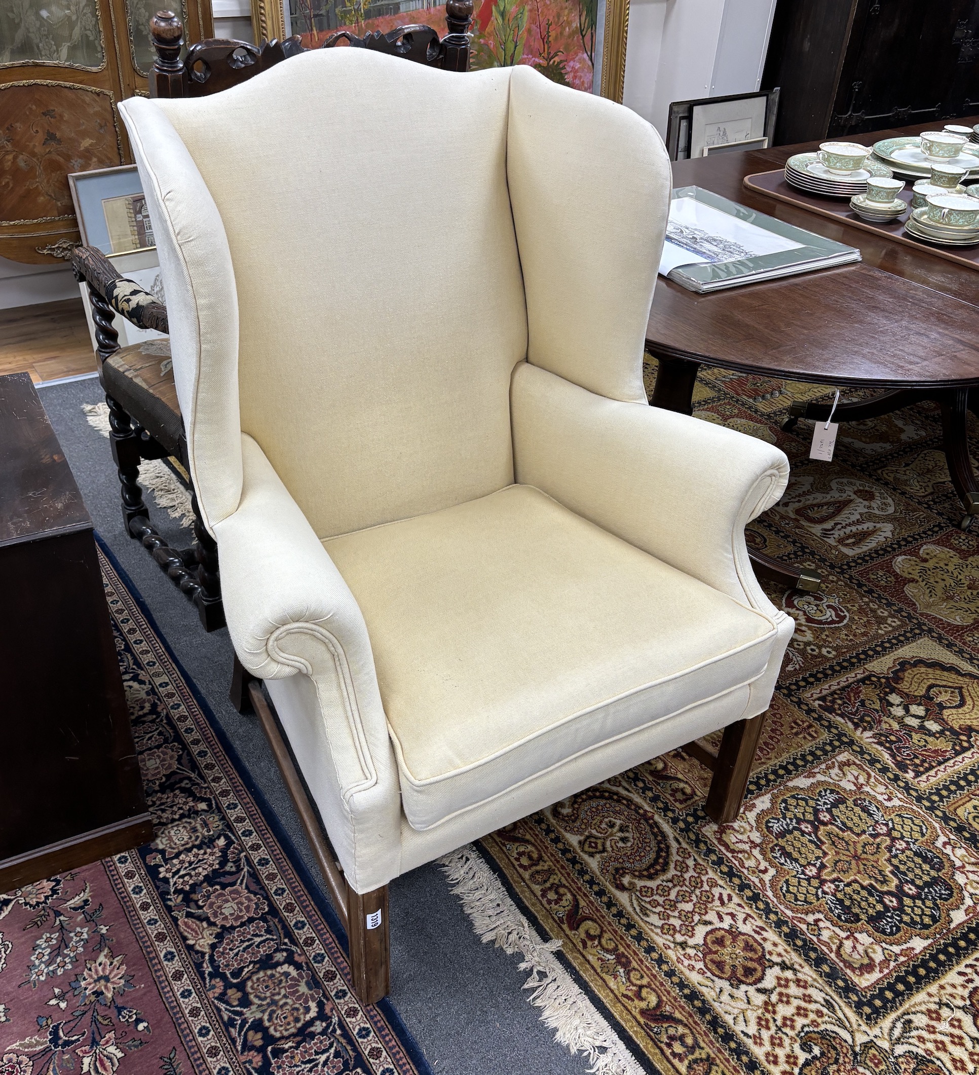 A Chippendale style mahogany framed upholstered wing armchair, width 86cm